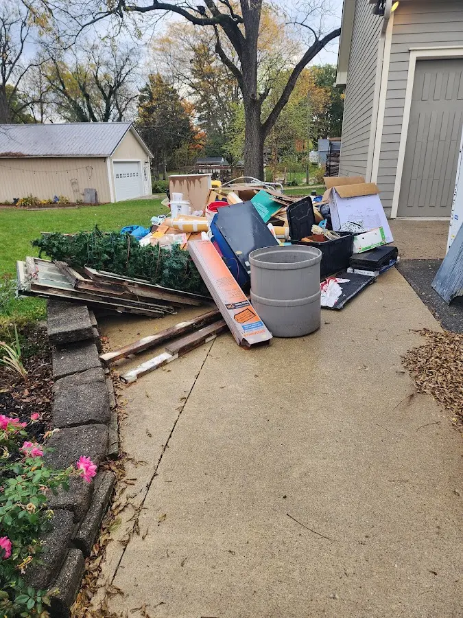 Dumpster being loaded with debris for 12 Yard Dumpster Rental in Carthage